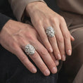 Load image into Gallery viewer, Polished 925 sterling silver matching Greek god Poseidon rings worn on the fingers of a man and woman together, showcasing three-dimensional bearded deity portraits, intricate hair details, and bright polished silver finishes.