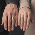 Load image into Gallery viewer, Gold plated 925 sterling silver matching Aztec Mayan rings worn on the fingers of a man and woman together, featuring intricate Mesoamerican-inspired symbols, repeating stepped patterns, and coordinated warm gold finishes.