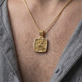 Load image into Gallery viewer, Gold Plated Saint George Dragon Slayer pendant worn on a man's chest with an open black shirt, displaying its sculptural Christian design.