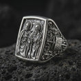 Load image into Gallery viewer, Oxidized Silver Saint Peter and Paul signet ring on black volcanic rock, featuring both haloed apostles with detailed keys, sword, and book symbolism.