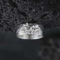 Load image into Gallery viewer, Polished 925 sterling silver octopus ring displayed against black volcanic stone, showcasing a three-dimensional octopus with intertwined tentacles, detailed suction cups, rounded head, smooth wide band, and bright polished silver finish.