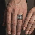Load image into Gallery viewer, Oxidized Silver Saint Paul Apostle rings worn on the fingers of a man and woman together, showcasing the detailed saint portraits and cross-decorated bands.