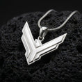 Load image into Gallery viewer, Polished sterling silver House Atreides necklace displayed on dark volcanic stone, highlighting the sharp hawk symbol, clean raised borders, and futuristic sci-fi styling.
