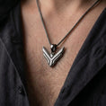 Load image into Gallery viewer, Black rhodium plated House Atreides pendant worn on the chest, showcasing the stylized hawk symbol, layered geometric details, and distinctive Dune inspired aesthetic.

