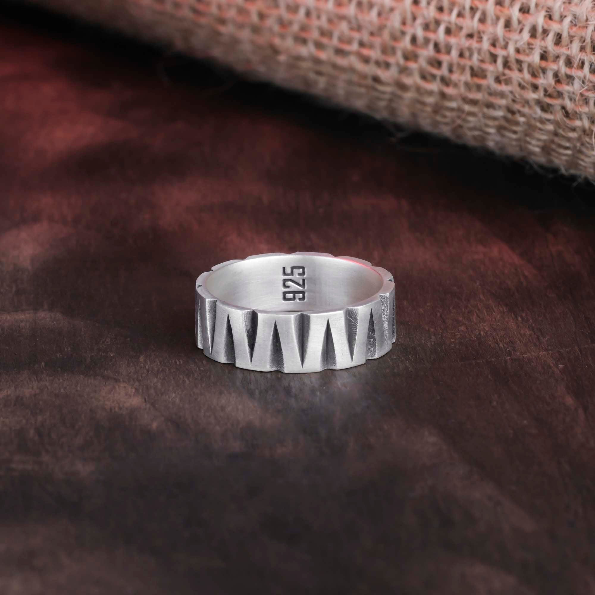 Overhead shot of the silver band ring, showcasing its minimalist style