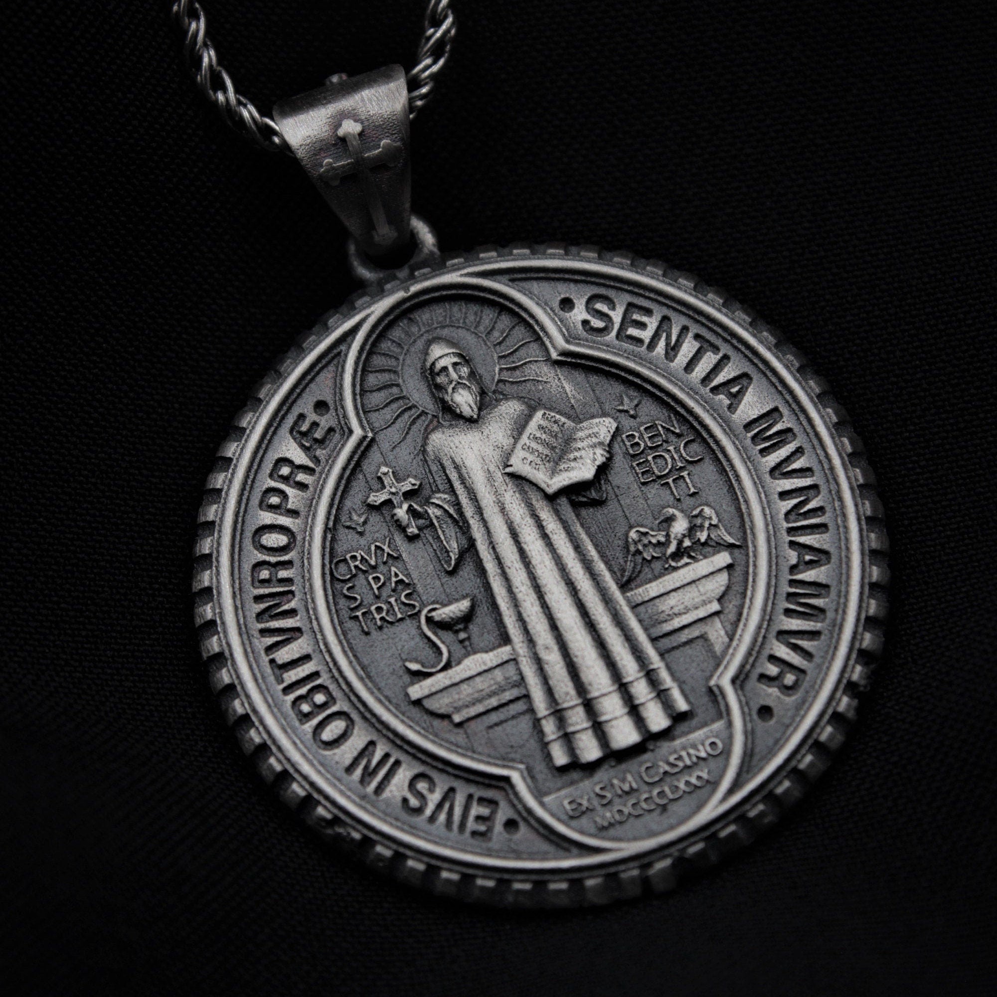 Catholic protection pendant, featuring the Cross of St. Benedict.