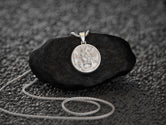 Rhodium-plated hope in God charm, polished devotional piece.
