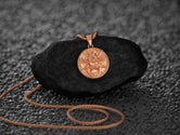Rose gold-plated hope charm, soft and inspiring tone.