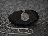 Christian pendant with Latin phrase, elegant and symbolic.