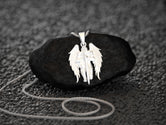 Rhodium-plated angel shield pendant, elegant and strong.