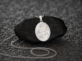 Rhodium-plated oval angel charm, spiritual jewelry piece.