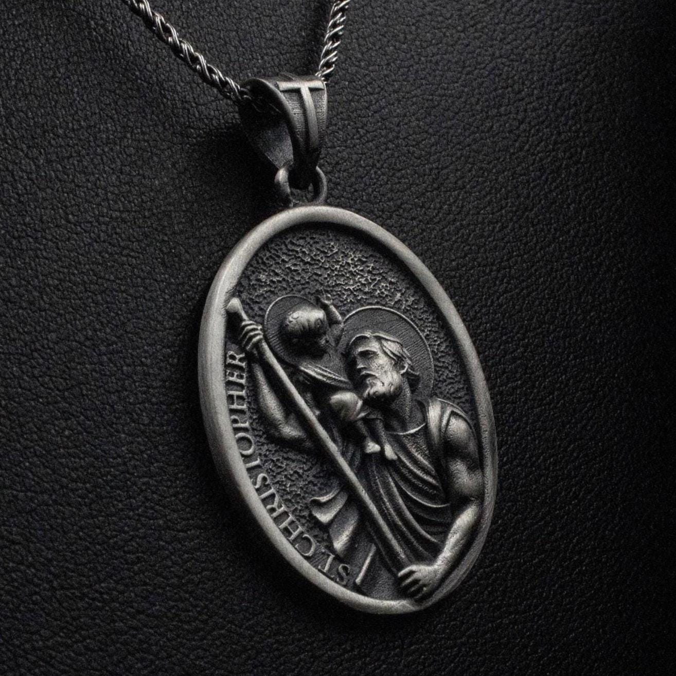Close-up of St. Christopher medal necklace, patron saint of travelers.