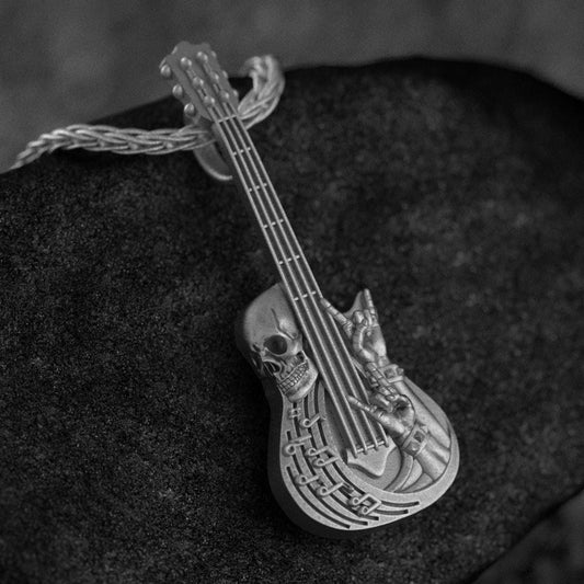 Oxidized silver skull guitar pendant with music-themed design,