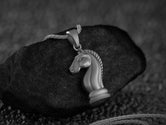 Strategic horse head game piece necklace,