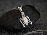 Scorpio zodiac sign pendant, detailed silver craftsmanship.
