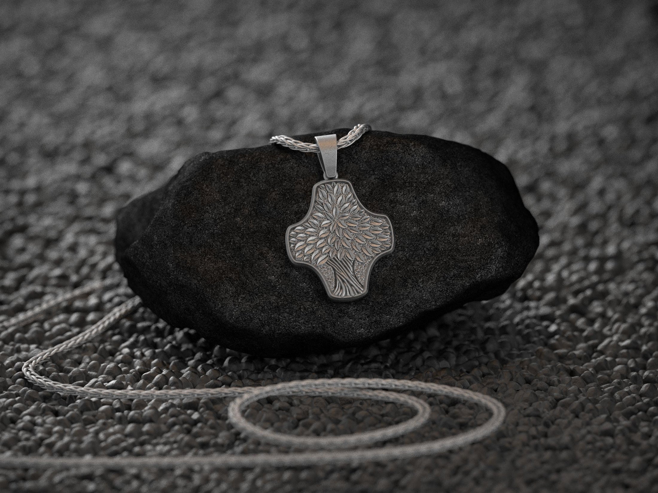 Close-up of tree bark textured silver pendant, modern nature jewelry.