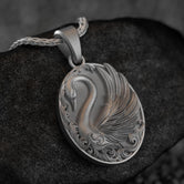 Close-up of elegant swan necklace, nature-inspired jewelry.