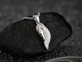 Polished silver winged horse pendant with angelic detail,