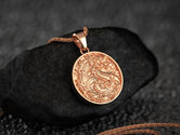 Rose gold dragon pendant featuring detailed Chinese mythical beast on ornate medallion,