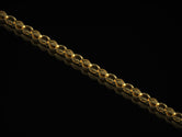 Gold-plated engraved eye link chain on dark background