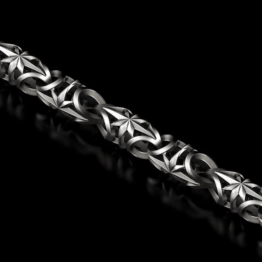 Oxidized silver chain with engraved star pattern on each link