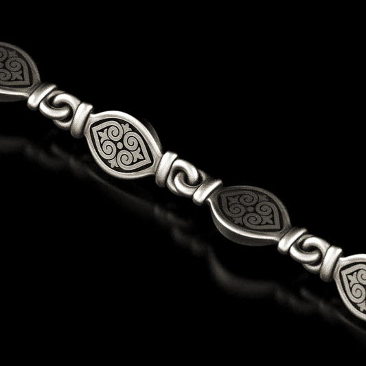 Close-up of oxidized 925 silver tribal necklace with swirl patterns,