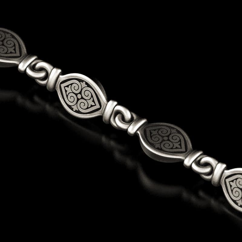 Close-up of oxidized 925 silver tribal necklace with swirl patterns,