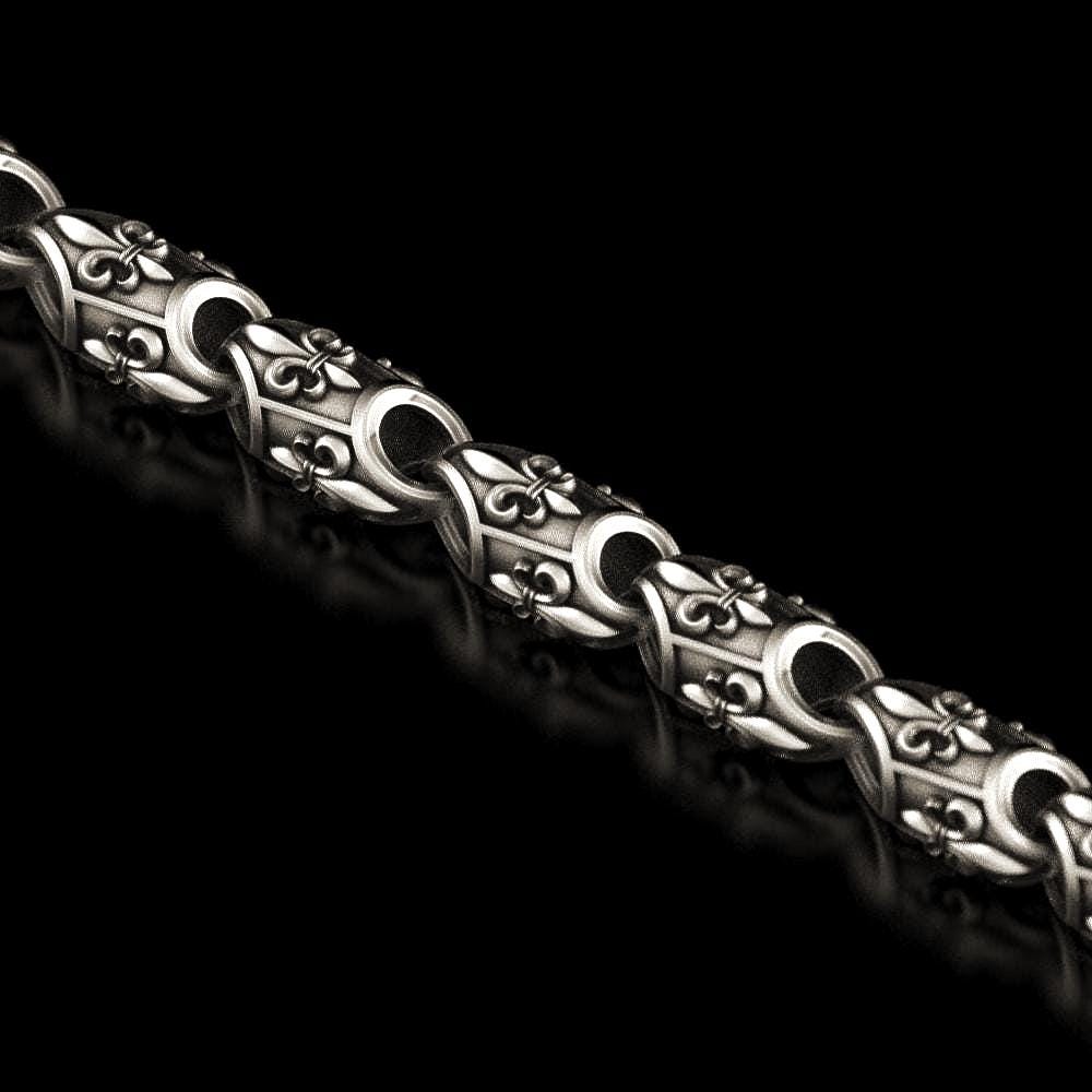 Close-up of fleur-de-lis pattern sterling silver chain