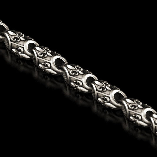 Close-up of fleur-de-lis pattern sterling silver chain
