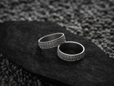 Pair of engraved dark silver star-pattern rings with comfort fit