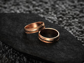 Rose gold matching wedding bands with engraved flow lines
