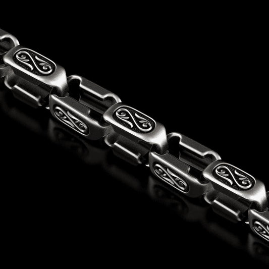 Close-up engraved scroll detail on silver link