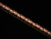 Rose gold chain with spiral symbols