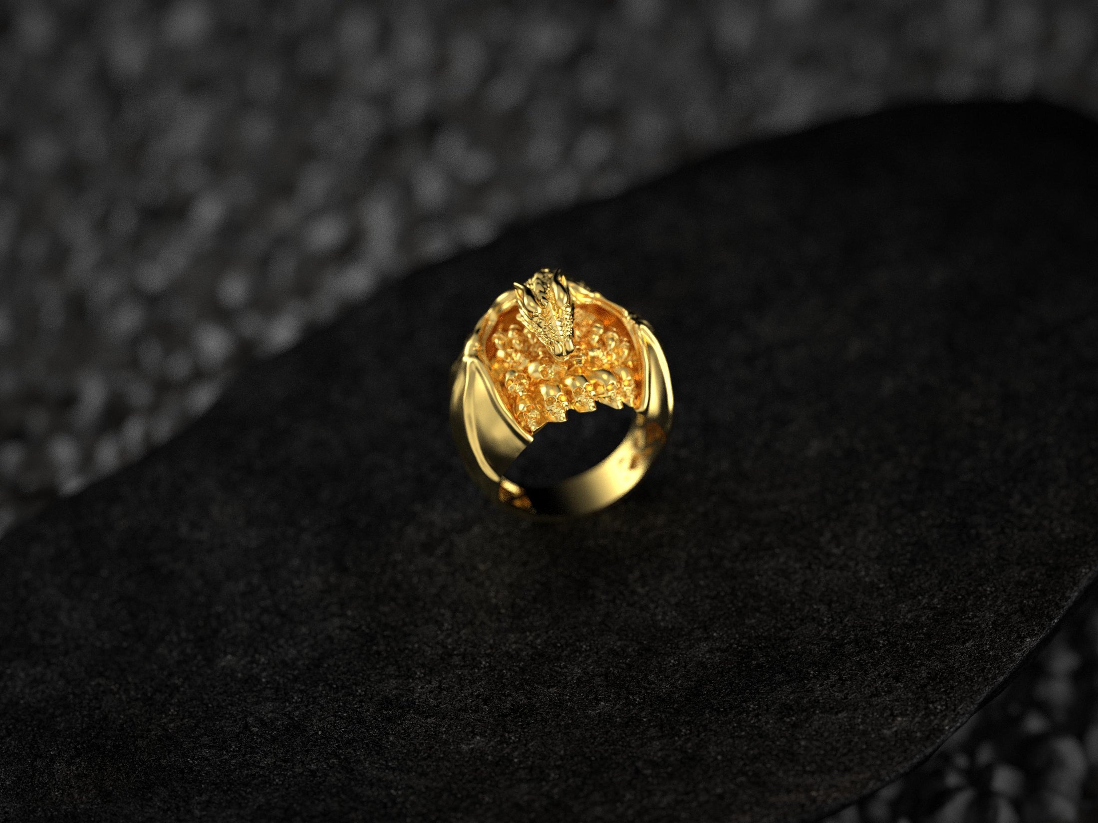 Front view of gold-plated dragon and skull ring.