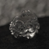 Front close-up of Medusa head ring in silver finish.