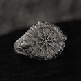 Load image into Gallery viewer, Front close-up of sterling silver Vegvísir signet ring on black stone.
