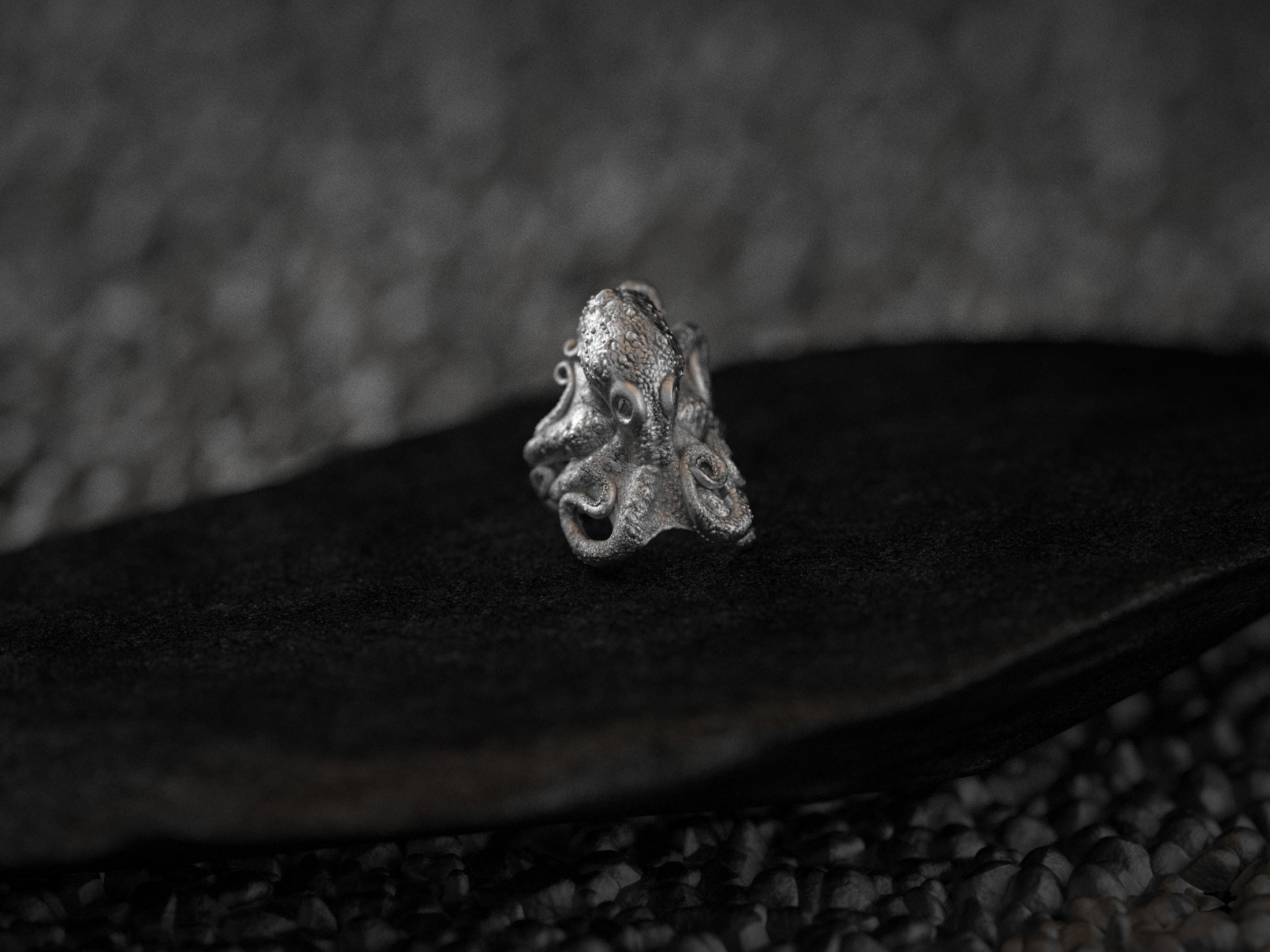 Angled view of silver octopus ring highlighting textured tentacles.