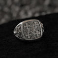 Load image into Gallery viewer, Front-view of the oxidized silver signet ring engraved with the five-cross Jerusalem motif, set on black stone.
