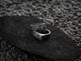 Bild in Galerie-Betrachter laden, Angled shot of the silver ring, displaying the polished band tapering into the detailed bar top.
