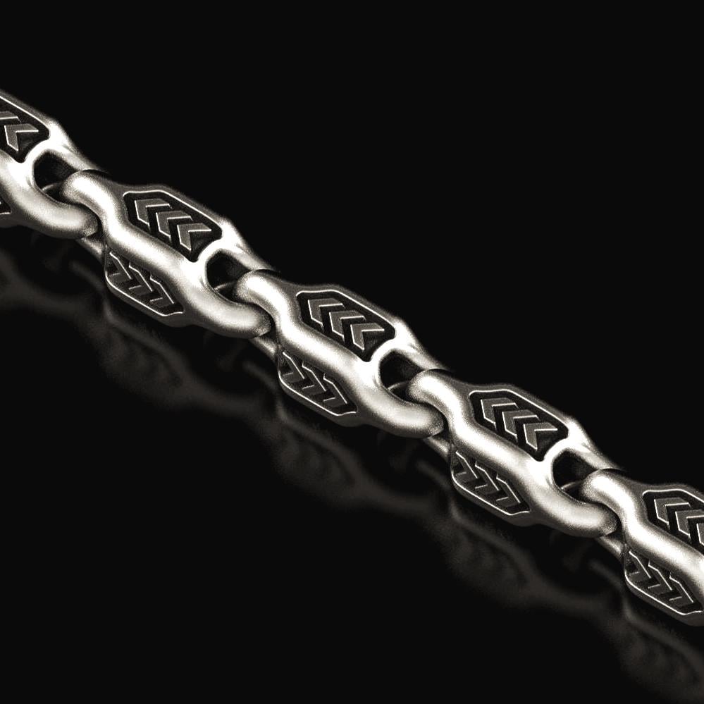 Close-up of oxidized arrowhead chain links