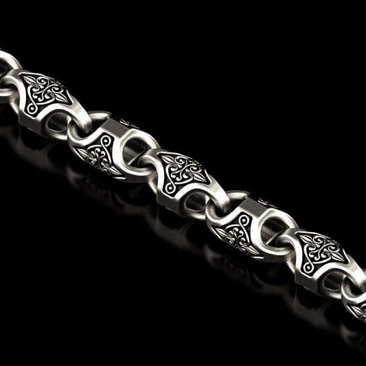 Close-up of oxidized Viking knot link in silver