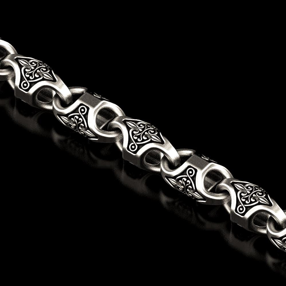 Close-up of oxidized Viking knot link in silver