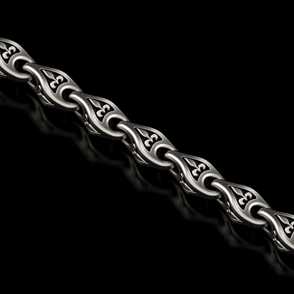 Close-up of oxidized Fleur-de-Lis chain link