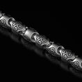 Load image into Gallery viewer, Close-up of silver triskele chain links
