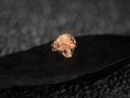 Load image into Gallery viewer, Front view of rose gold-plated skull ring highlighting skull design.
