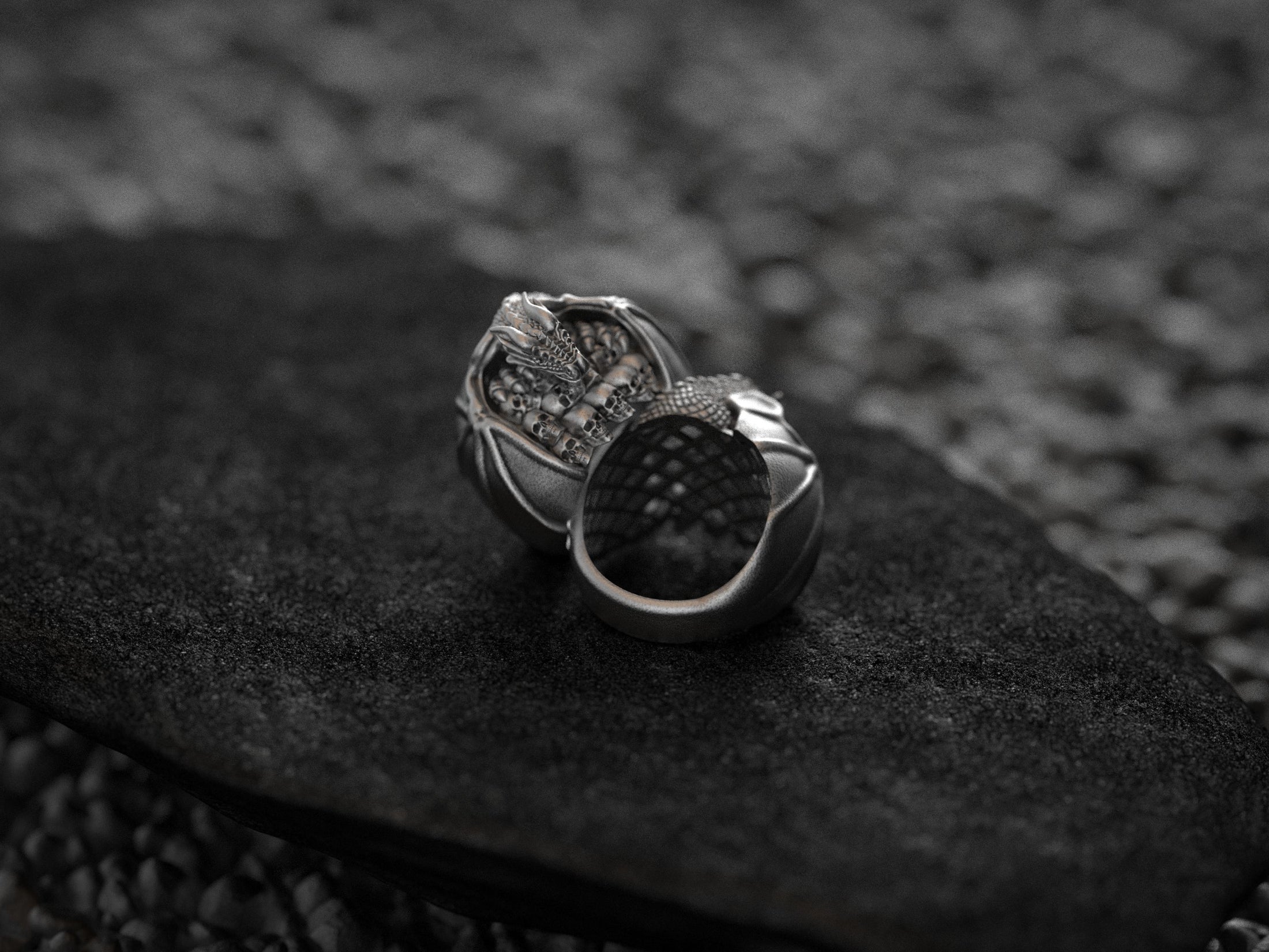 Side profile of silver ring showcasing dragon wings.