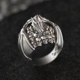 Front close-up of silver dragon skull signet ring.