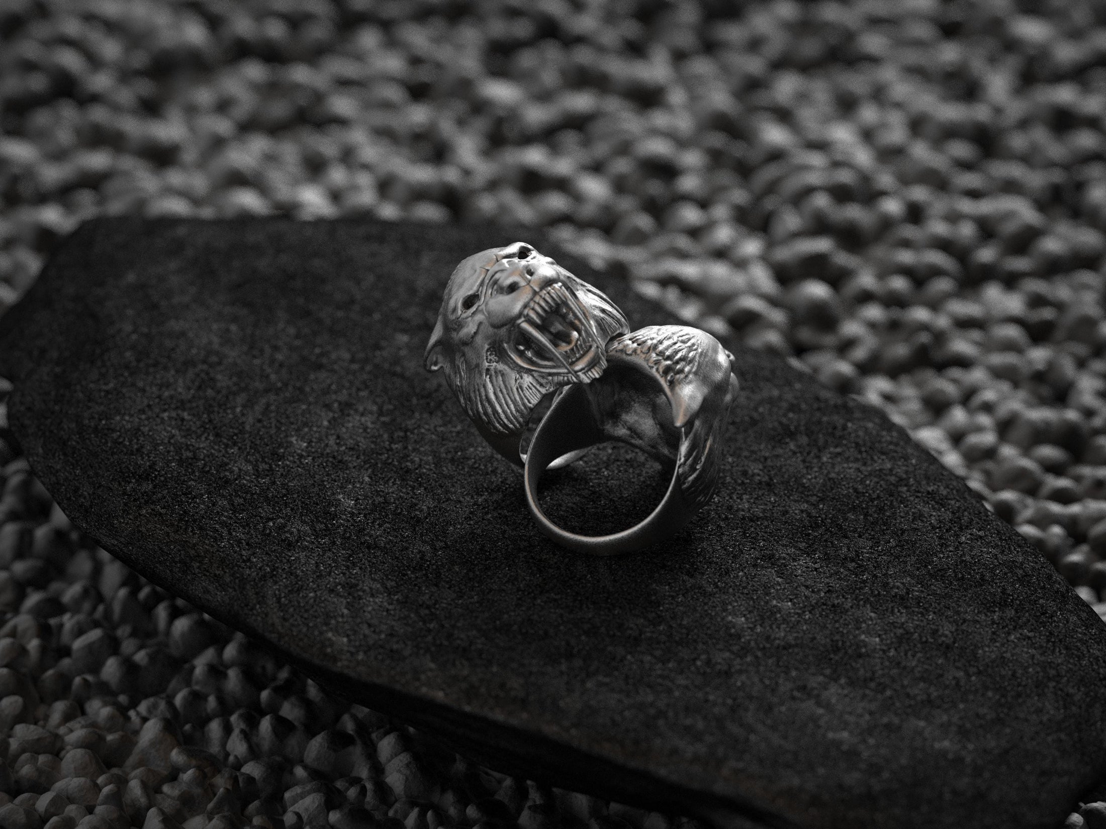 Side profile of silver ring highlighting fur and teeth texture.