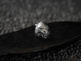 Load image into Gallery viewer, Angled view of silver werewolf ring on dark stone background.
