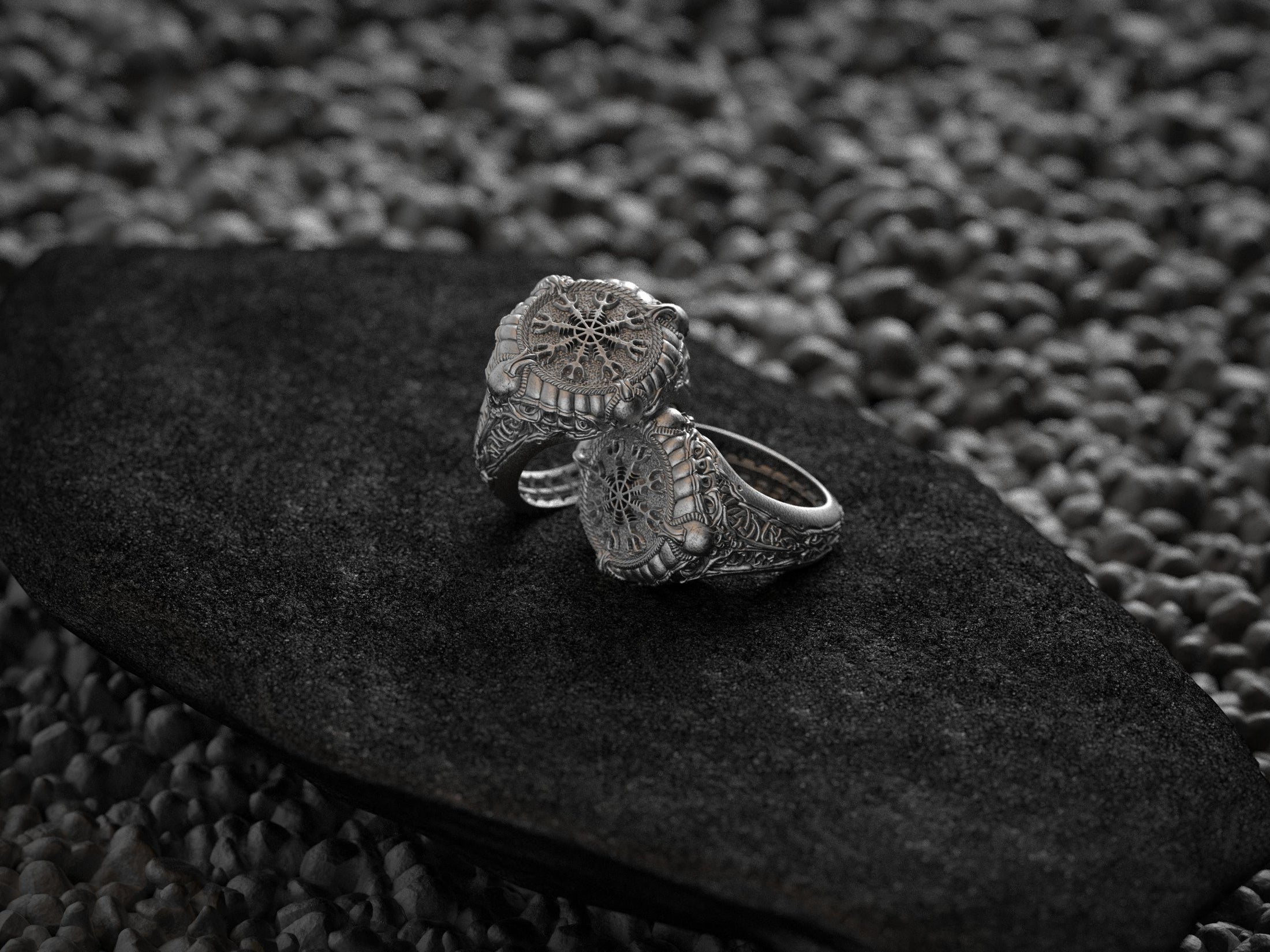 Side profile of silver ring band with Norse rune patterns.